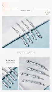 Macro shot of silver hair clips set featuring teardrop-shaped zircon stones and rhinestones