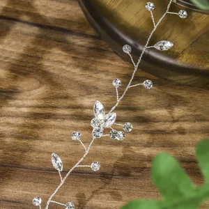 Detailed close-up of handmade silver bridal hair vine with sparkling crystals and wire