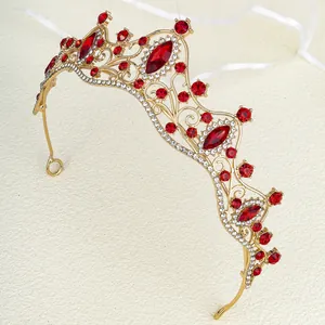 Macro detail of royal gold crown with large red rhinestones and micro white crystals