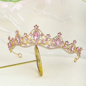 Detailed view of luxury gold tiara with pink rhinestones and elegant floral metalwork