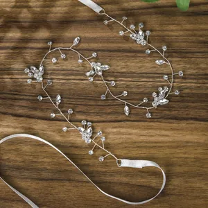 Macro view of handmade crystal bridal headband with silver wire and white silk ribbon