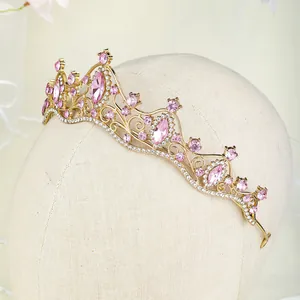 Detail of bridal gold tiara with pink marquise crystals and white rhinestones