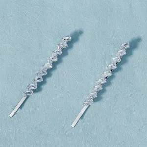 Close-up of silver hair pins with rectangular cubic zirconia stones in diagonal layout
