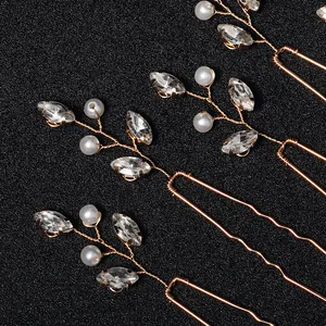 Elegant gold bridal hair pins with pearls and sparkling rhinestones for wedding hair styling