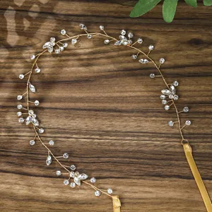 Macro detail of handmade gold bridal headband with crystals, pearls and silk ribbons