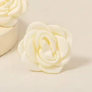 Macro detail of elegant cream silk artificial rose bridal hair pin with satin petals