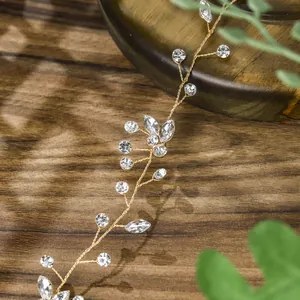 Detailed close-up of handmade bridal crystal hairband with gold wire and clear rhinestones