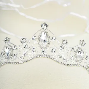 Macro shot of silver bridal tiara showing intricate rhinestones and central teardrop gem