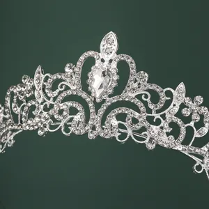 Luxurious silver bridal crown with intricate filigree and sparkling teardrop rhinestones