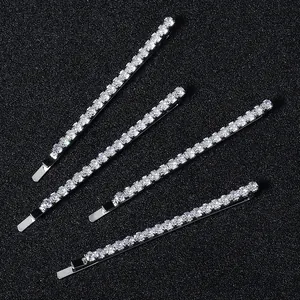 Elegant four-piece silver metal hair clips set with sparkling round rhinestones on black