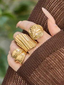 Detailaufnahme von drei 18k vergoldeten Edelstahlringen mit Hammerschlag und Texturierung