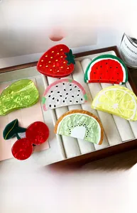 Selection of vibrant acetate fruit-shaped hair claws including watermelon and strawberry