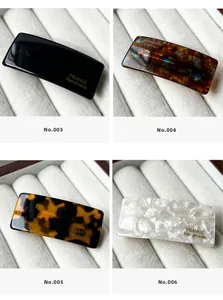 Detail showing acetate hair clips in four patterns with gold France Handmade logo