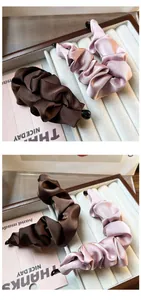 Detail of satin pleated banana hair clips in brown and pink colors with smooth texture