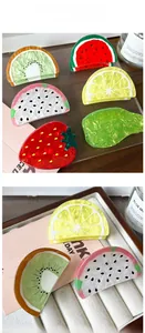 Detail of colorful PVC fruit claw clips with watermelon and pineapple marble patterns