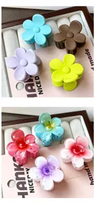 Close-up of floral mini hair claws in matte and translucent gradient finishes on display