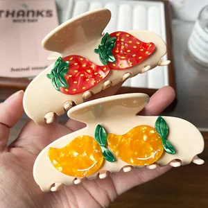 Set of two cute fruit acetate hair claws with strawberry and yellow fruit designs