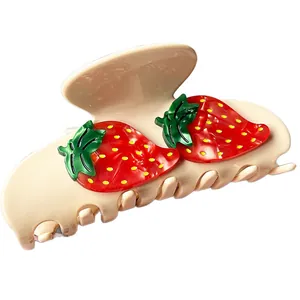 Elegant acetate hair claw clip with cute 3D strawberry design on a white background