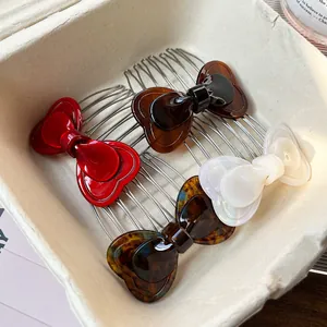 Four-piece acetate bow hair side combs in red, brown, pearl white, and tortoiseshell