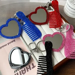 Portachiavi con specchio a cuore e mini pettine in acrilico glitterato multicolore