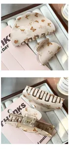 Detail of coffee butterfly hair clips set with smooth texture and spring mechanism