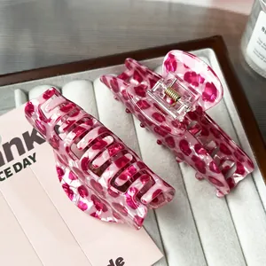 Pink leopard pattern hair claw clip with strong gold spring in premium jewelry tray