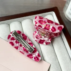 Pink leopard acetate hair clip set featuring a claw clip and hair barrette on velvet
