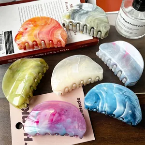 Set of large marble pattern hair claws in assorted pastel colors for elegant hair styling