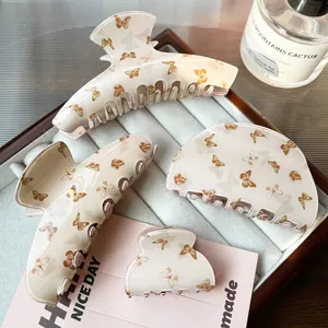 4-piece set of cream and amber butterfly hair clips in various sizes for stylish hair styling