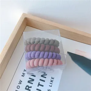 Set de cuatro gomas de pelo en espiral mate Morandi en caja de plástico