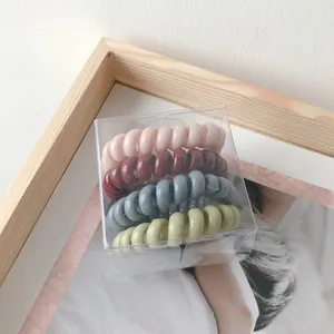 Set de 4 gomas de pelo en espiral mate en colores Morandi en caja transparente