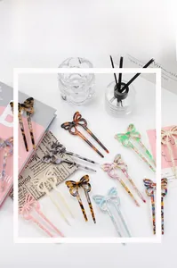 Close-up of assorted acetate butterfly hair sticks in marble and tortoiseshell patterns