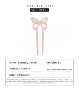 Pink acetate butterfly hairpin with product dimensions measuring 11.8cm by 5.2cm