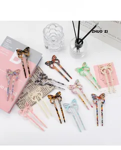 Detail of elegant acetate butterfly hair sticks in multiple colorful marble textures