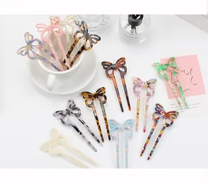 Detail view of assorted acetic acid butterfly hair sticks in multiple elegant marble patterns