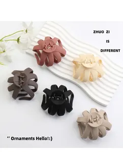 Detail of matte octopus hair claws in five neutral earth tones on display stand
