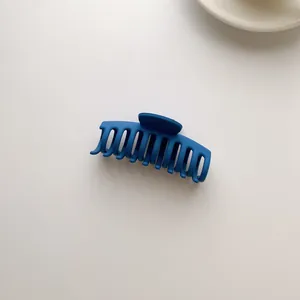 Macro detail of matte Klein blue hair claw clip with a minimalist textured surface