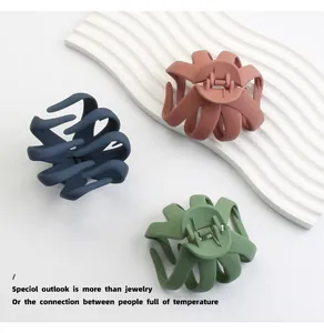 Close-up of three matte Morandi octopus hair claws in blue, pink, and green colors