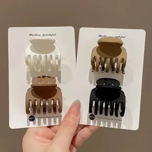 Set di mollette per capelli opache in nero, marrone e cachi per acconciature a coda