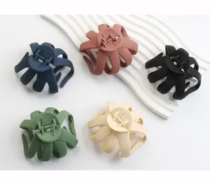 Macro detail of octopus claw hair clips in five matte Morandi colors with strong metal spring