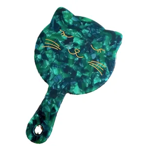 Cat-shaped hand mirror in green marble acetate finish with minimalist gold cat face details