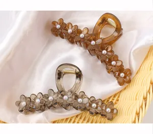 Close-up of jelly texture floral hair claw clips with elegant pearl centers and metal spring