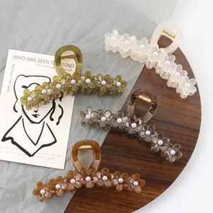 Set of four flower-shaped resin hair claws with pearl center in jelly colors for women