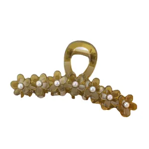 Translucent brown flower hair claw clip with pearl accents and golden metal spring