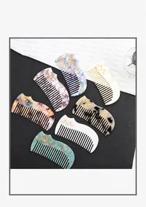Detailed set of acetate cat-shaped hair combs showing marble and tortoiseshell patterns