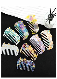 Detailed close-up of acetate cat-shaped hair combs with colorful marble patterns