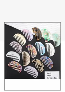 Flat lay of colorful acetate hair combs with marble and tortoiseshell patterns