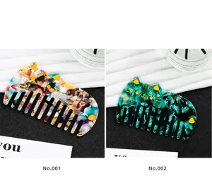 Detailed comparison of marble textured cat hair combs in floral and emerald green acetate