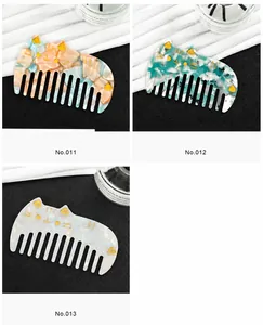 Detailed view of three cat-shaped acetate hair combs in pastel marble patterns No.011-013