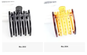 Vue détaillée de grandes pinces à cheveux en noir brillant et motifs d'écaille d'ambre